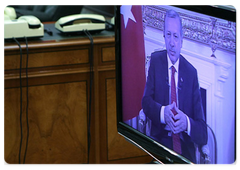 Russian Prime Minister Vladimir Putin and Italian Prime Minister Silvio Berlusconi in a videoconference with their Turkish counterpart Recep Tayyip Erdogan