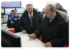 Vladimir Putin attending the startup ceremony for the East Siberia-Pacific Ocean oil pipeline system and gave the signal for the first tanker shipment