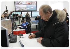 Vladimir Putin attending the startup ceremony for the East Siberia-Pacific Ocean oil pipeline system and gave the signal for the first tanker shipment