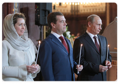Russian President's spouse Svetlana Medvedeva, Russian President Dmitry Medvedev and Vladimir Putin at an Easter service in Moscow's Christ the Saviour Cathedral