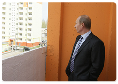 Prime Minister Vladimir Putin visiting the Astrakhan centre to see dilapidated residential houses and old barracks