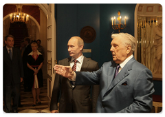 Prime Minister Vladimir Putin congratulating artist Ilya Glazunov on his 79th birthday during a visit to his gallery