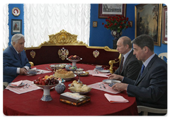 Prime Minister Vladimir Putin and Culture Minister Alexander Avdeyev visit Ilya Glazunov at his gallery to congratulate him on his 79th birthday