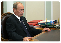 Prime Minister Vladimir Putin during a working meeting with Sberbank CEO German Gref