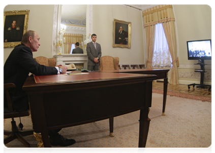 Prime Minister Vladimir Putin holding a video conference with officials at the Sayano-Shushenskaya hydroelectric power station to celebrate the restoration of power unit No. 3 after a recent accident