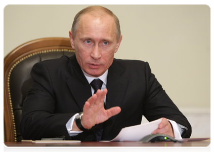 Prime Minister Vladimir Putin holding a video conference with officials at the Sayano-Shushenskaya hydroelectric power station to celebrate the restoration of power unit No. 3 after a recent accident