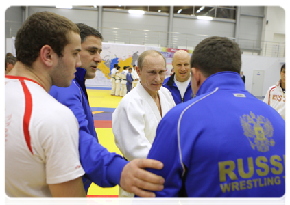Prime Minister Putin talking with the Russian wrestling team after their training session