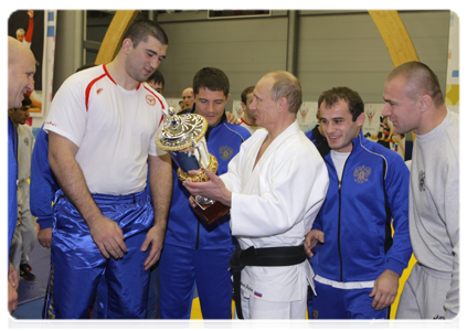 Prime Minister Putin talking with the Russian wrestling team after their training session