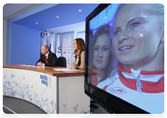 Prime Minister Vladimir Putin speaking with the Russian Olympic team at the Russian House in Vancouver during a video conference at the Olympic Information Centre, Sochi 2014