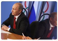 Prime Minister Vladimir Putin speaking with the Russian Olympic team at the Russian House in Vancouver during a video conference at the Olympic Information Centre, Sochi 2014