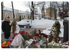 While on a working trip to St Petersburg, Prime Minister Vladimir Putin visits St Nicholas Cemetery to lay red roses at the tomb of Anatoly Sobchak