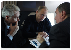 Prime Minister Vladimir Putin, Deputy Prime Minister Igor Sechin and Chief of the Government Executive Office Sergei Sobyanin in a helicopter flying to the Sayano-Shushenskaya Hydroelectric Power Plant
