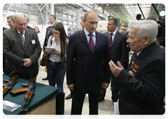 Prime Minister Vladimir Putin speaking with Lieutenant General Mikhail Kalashnikov, the designer of the AK-47 assault rifle, at Izhmash Holding