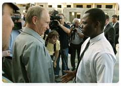 Prime Minister Vladimir Putin meeting with Vasily Krima, born in Guinea-Bissau, during his visit to the construction site for a housing development for servicemen in the Sovetsky district of Volgograd