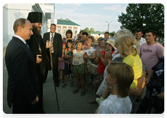 Prime Minister Vladimir Putin visiting a church in the village of Tulinovka