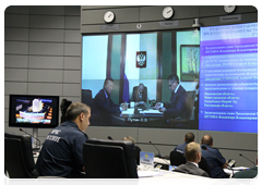 Prime Minister Vladimir Putin during a conference call on measures to reduce the incidence of wildfires
