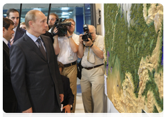 Prime Minister Vladimir Putin inspecting plans for airport construction and renovation during his visit to North Caucasus Federal District