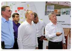 Prime Minister Vladimir Putin perusing information on the progress of work on the Vostochny national cosmodrome
