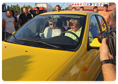 A long-haul driver, Alexander Sakharov, asked Mr Putin to show him the Lada Kalina car he was riding in. Mr Putin suggested he take a test drive