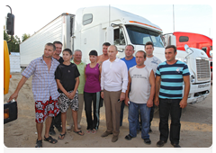 Prime Minister Vladimir Putin speaking with long-haul lorry drivers during a stop on his trip along the Amur Highway