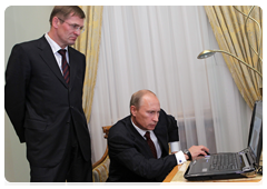 Prime Minister Vladimir Putin at a meeting with Sergei Vasilyev, the director of the Federal Service of State Registration, Cadastre and Cartography and the main state registrar of the Russian Federation