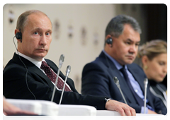 Prime Minister Vladimir Putin, Emergencies Minister Sergei Shoigu and Editor-in-Chief of the Russian News & Information Agency Svetlana Mironyuk