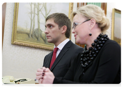 Formula 1 driver Vitaly Petrov and his manager Oksana Kosachenko at a meeting with Prime Minister Vladimir Putin