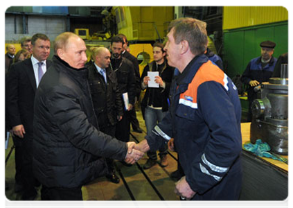 Prime Minister Vladimir Putin speaking with workers during his visit to the Proletarsky Zavod plant in St Petersburg