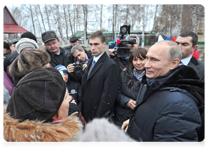 Prime Minister Vladimir Putin meeting with local residents during his visit to the village of Golovchino