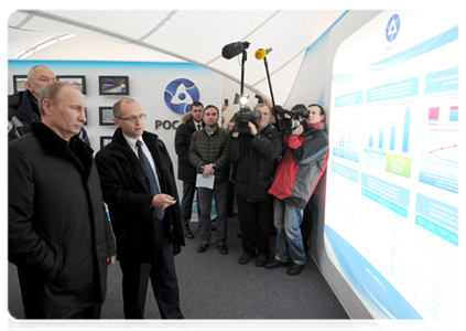 Prime Minister Vladimir Putin visits display stands featuring information on the Kalininskaya Nuclear Power Plant construction, prior to the commissioning ceremony of the plant's fourth unit