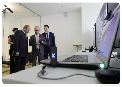 Prime Minister Vladimir Putin examines new developments in the telecommunications sector