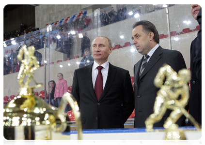 Prime Minister Vladimir Putin hands the Golden Puck Youth Hockey Cup to the Chelyabinsk White Bears after the game