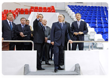 Prime Minister Vladimir Putin inspects the construction of a multi-purpose stadium