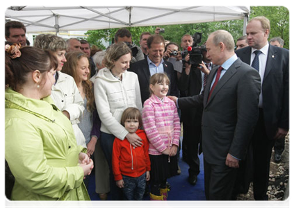 Prime Minister Vladimir Putin inspecting courtyards and talking to local residents during a working visit to Pskov