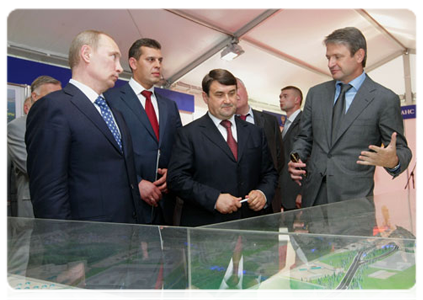 Prime Minister Vladimir Putin is shown an exhibition devoted to the history of the Novorossiisk transport hub development