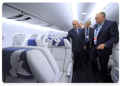 Prime Minister Vladimir Putin examines an MS-21 at the Unified Aircraft Corporation pavilion. The medium-range MS-21 jet is meant to replace the TU-154