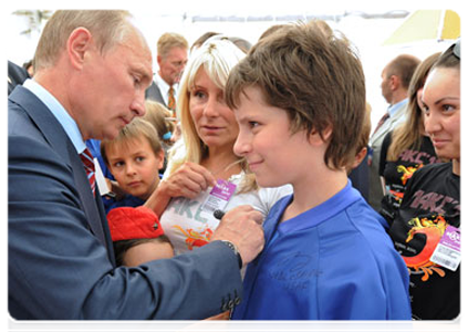 Prime Minister Vladimir Putin signing autographs at the end of his visit to the pavilion of the Clear Prop open festival of children's creative endeavours in Moscow