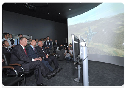 Prime Minister Vladimir Putin examines a breakthrough installation that models the performance of different kinds of military technology, in particular a mission by a Ka-52 “Alligator” helicopter unit