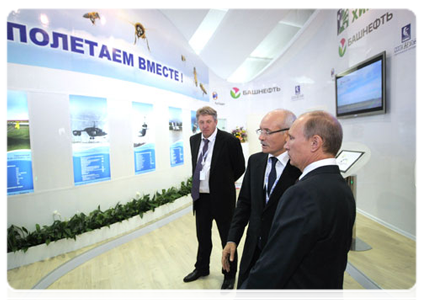 Prime Minister Vladimir Putin visiting innovation project displays from various regions at the X International Investment Forum Sochi-2011