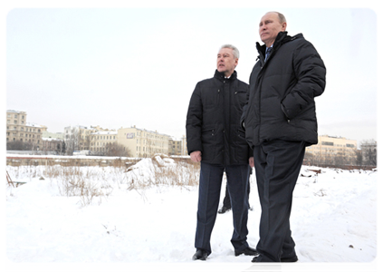 Prime Minister Vladimir Putin and Moscow Mayor Sergei Sobyanin inspect the construction site at the demolished Rossiya Hotel