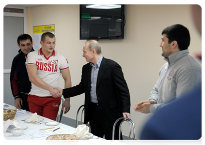 Prime Minister Vladimir Putin speaks with members of the national judo team during a visit to the Regional Judo Centre in Kemerovo