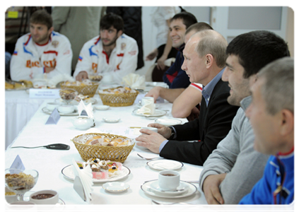 Prime Minister Vladimir Putin speaks with members of the national judo team during a visit to the Regional Judo Centre in Kemerovo