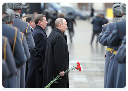 Prime Minister Vladimir Putin attends a wreath-laying ceremony on Defender of the Fatherland Day at the Tomb of the Unknown Soldier in Moscow
