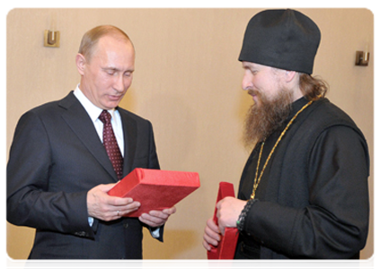 Prime Minister Vladimir Putin presents a 19th-century icon to the Sarov Monastery