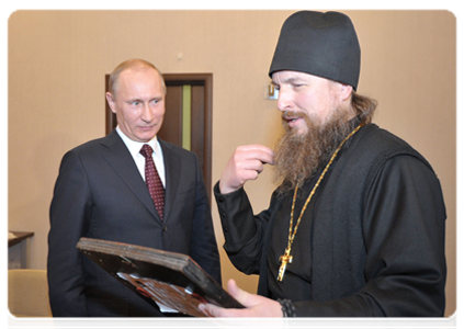 Prime Minister Vladimir Putin presents a 19th-century icon to the Sarov Monastery