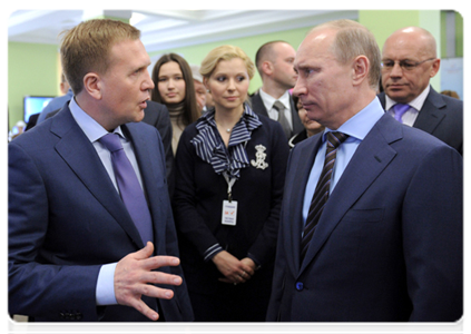 Vladimir Putin reviews the system for the webcam monitoring of polling stations during his visit to the 2012 election monitoring centre