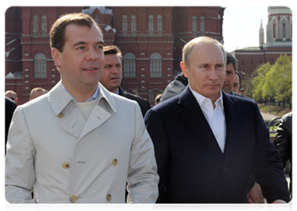 President Dmitry Medvedev and Prime Minister Vladimir Putin participate in a May Day parade