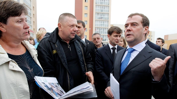 Prime Minister Dmitry Medvedev tours a new housing development